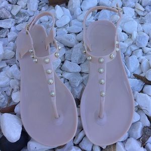 These flip flops are a size 4 light pink with pearls and only been worn once.